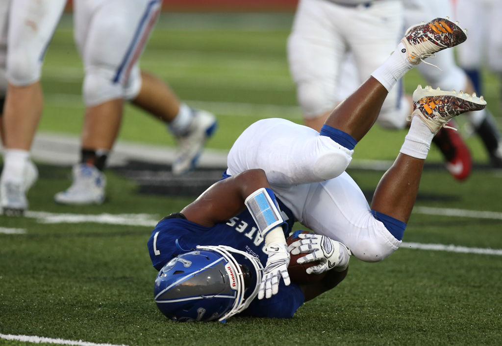 Avian Thomas, a running back for Boonville High School, tumbles after running the ball